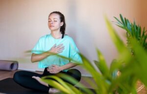A young lady is practicing mindful exercises to manage stress for a healthy gut Exploring the relationships between stress exercises role in gut function and overall well-being